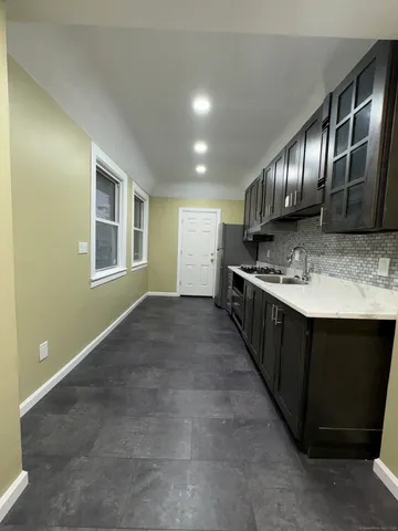 a kitchen with wooden cabinets and a sink