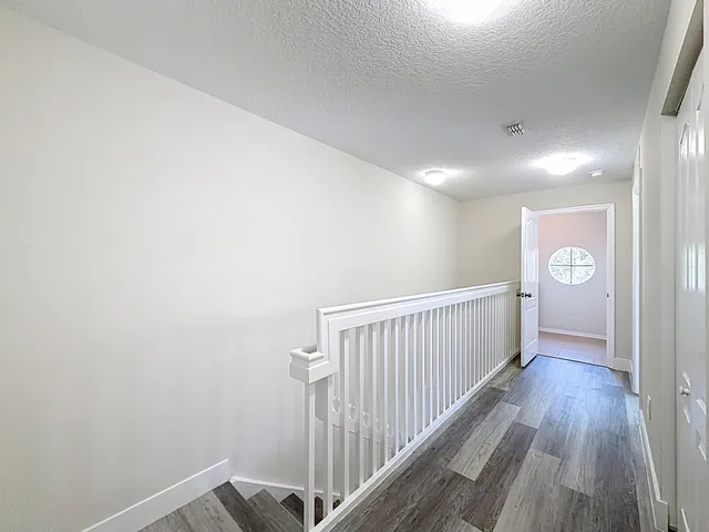 a view of hallway with wooden floor