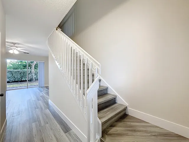 a view of entryway and hall with wooden floor