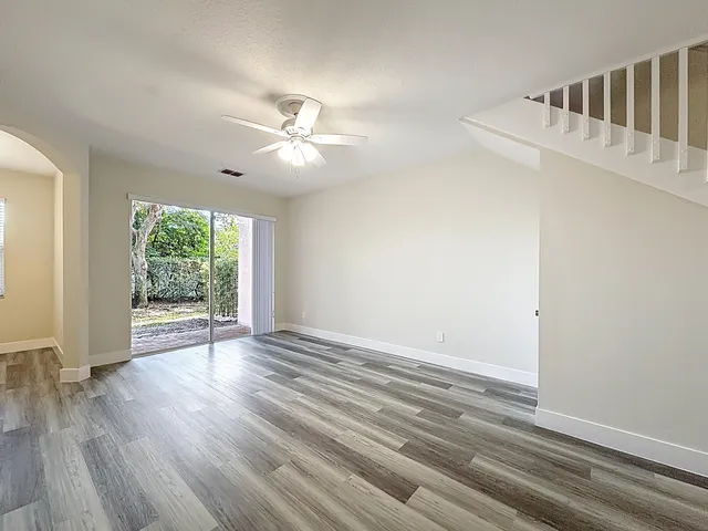 wooden floor in an empty room with a window