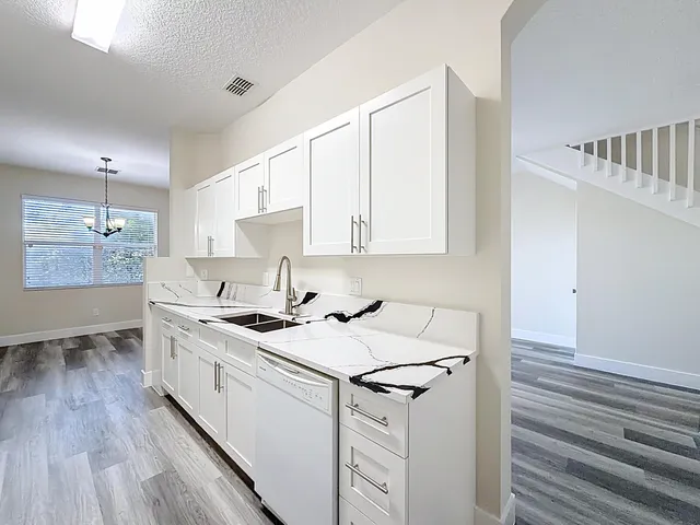 a kitchen with a sink stove and cabinets