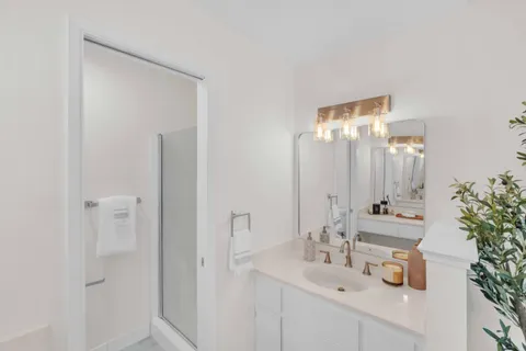 a bathroom with a double vanity sink and a mirror