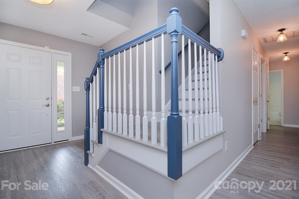 4306 Atkinson Way Monroe, NC 28110 - Photo 2 of 31 a view of a hallway with wooden floor and staircase