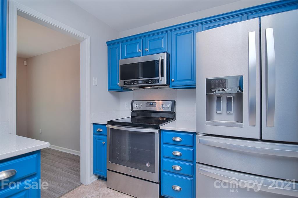 4306 Atkinson Way Monroe, NC 28110 - Photo 11 of 31 a kitchen with stainless steel appliances granite countertop a stove microwave and refrigerator