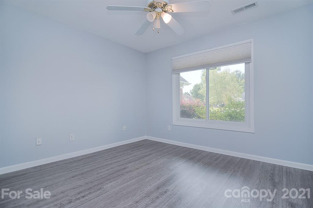 4306 Atkinson Way Monroe, NC 28110 - Photo 14 of 31 an empty room with wooden floor chandelier fan and windows