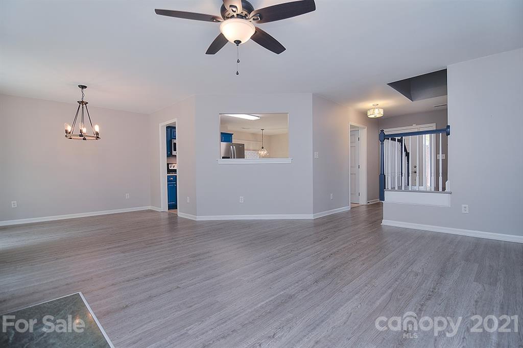 4306 Atkinson Way Monroe, NC 28110 - Photo 3 of 31 a view of an empty room with wooden floor and a ceiling fan