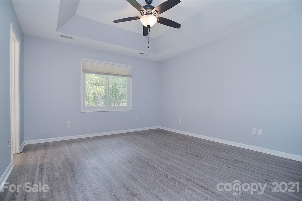 4306 Atkinson Way Monroe, NC 28110 - Photo 22 of 31 an empty room with wooden floor ceiling fan and window