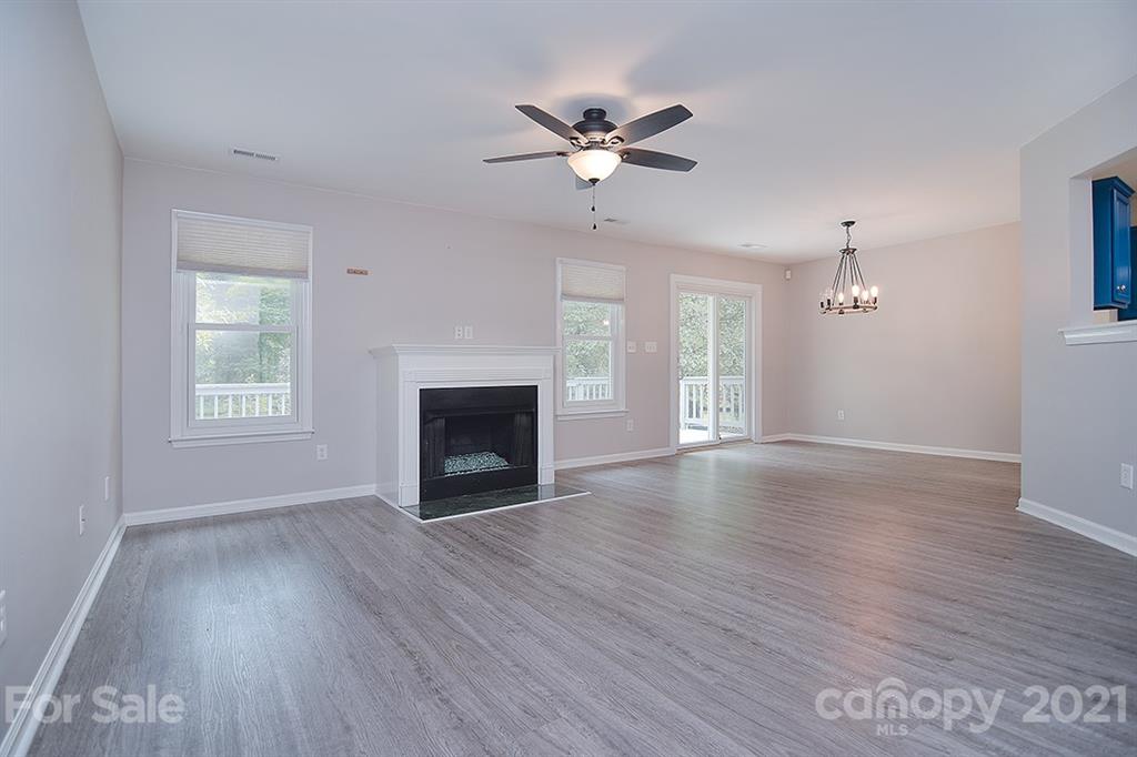 4306 Atkinson Way Monroe, NC 28110 - Photo 5 of 31 a view of an empty room with wooden floor and a window