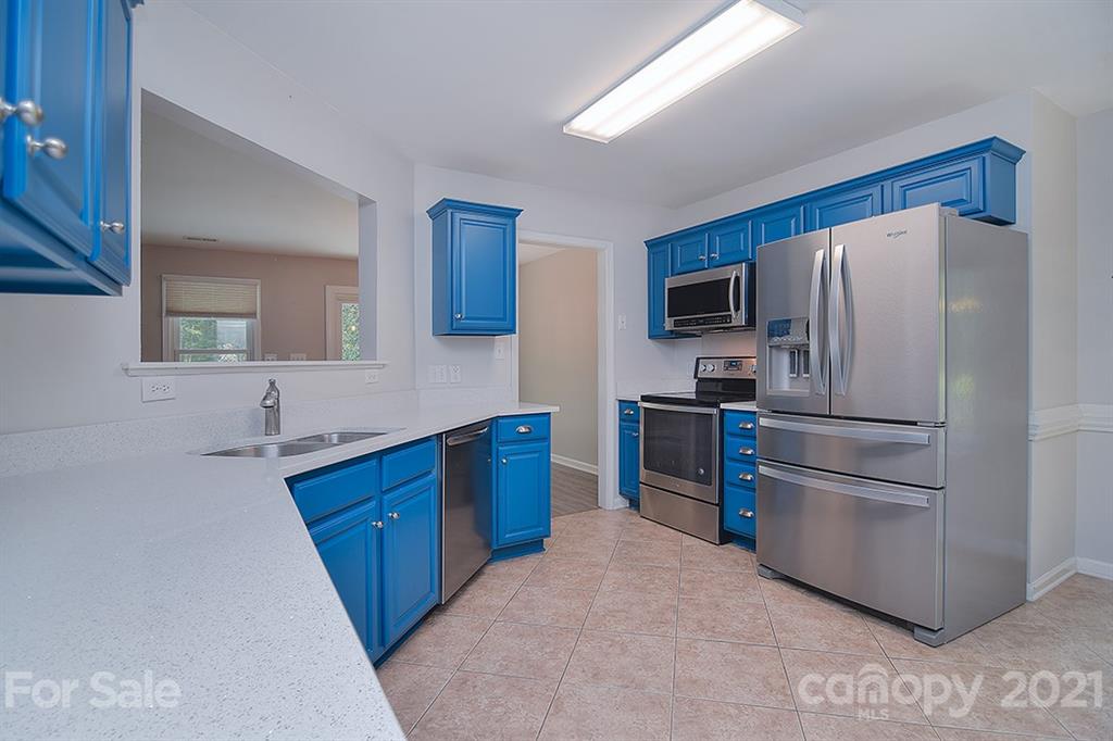 4306 Atkinson Way Monroe, NC 28110 - Photo 10 of 31 a kitchen with stainless steel appliances a refrigerator and a sink