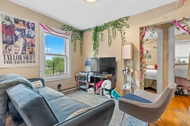 a living room with furniture and a flat screen tv