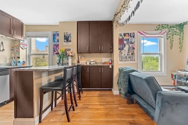 a kitchen with stainless steel appliances granite countertop a refrigerator and a table