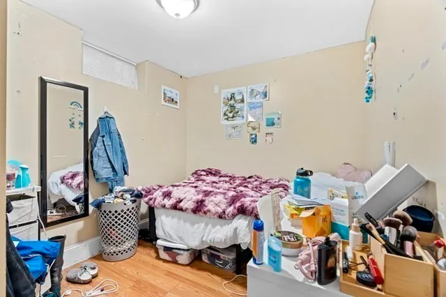 a bedroom with furniture and a wooden floor