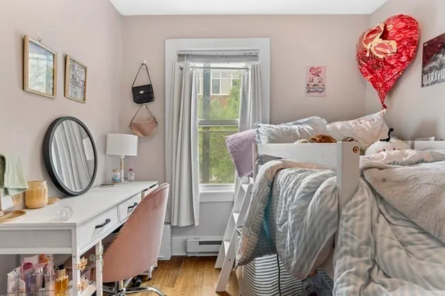 a bedroom with a bed and a painting on the wall