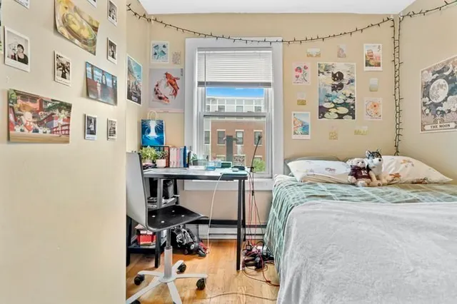 a bed room with a bed and a chair