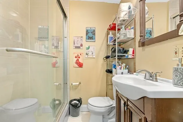 a bathroom with a sink toilet and shower