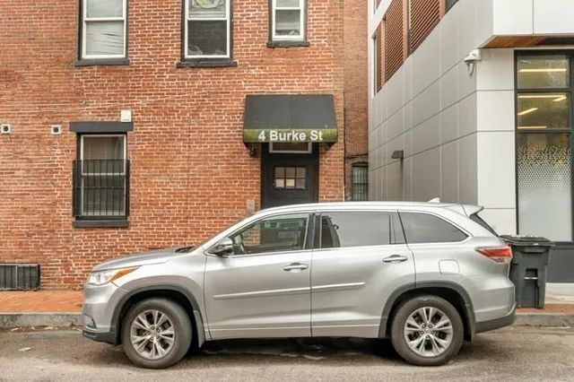 a view of a car that is parked in front of a building