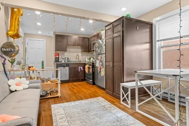 a kitchen with stainless steel appliances kitchen island granite countertop a refrigerator and a stove