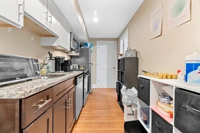 a kitchen with stainless steel appliances granite countertop a sink and dishwasher