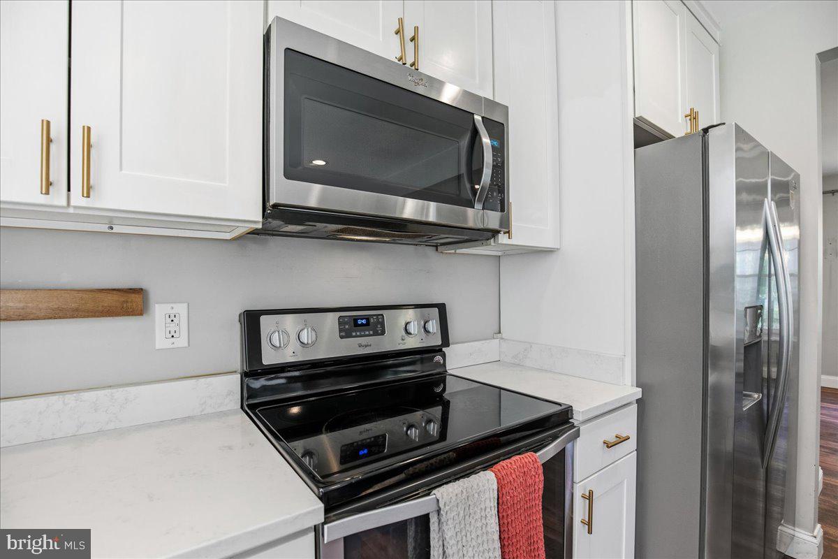 16146 Thomas Road Piney Point, MD 20674 - Photo 16 of 70 a kitchen with a stove and a microwave