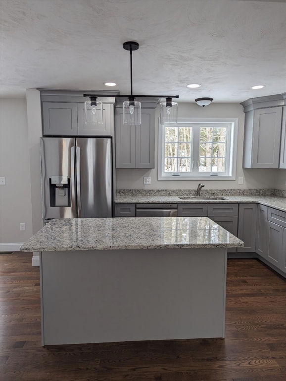 514 Old County Road Holland, MA 01521 - Photo 11 of 40 a large kitchen with granite countertop a sink a window and stainless steel appliances