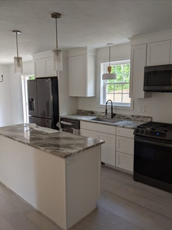 514 Old County Road Holland, MA 01521 - Photo 12 of 40 a kitchen with stainless steel appliances granite countertop a sink stove a refrigerator and a granite counter top