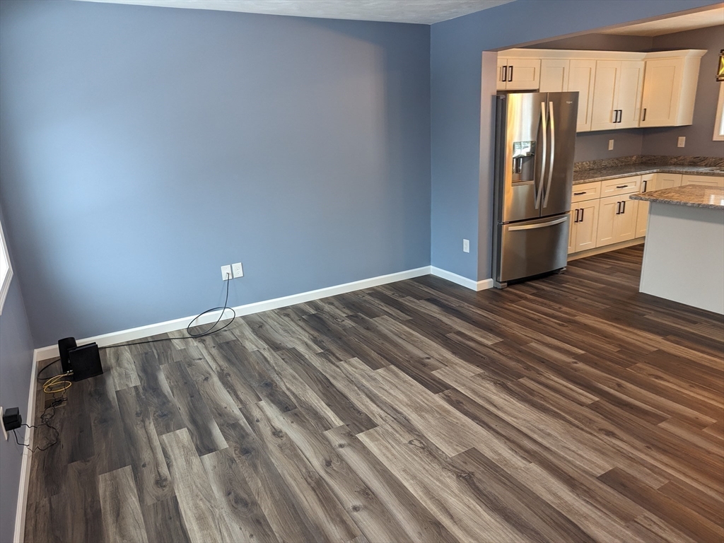 514 Old County Road Holland, MA 01521 - Photo 16 of 40 a kitchen with granite countertop white cabinets and stainless steel appliances