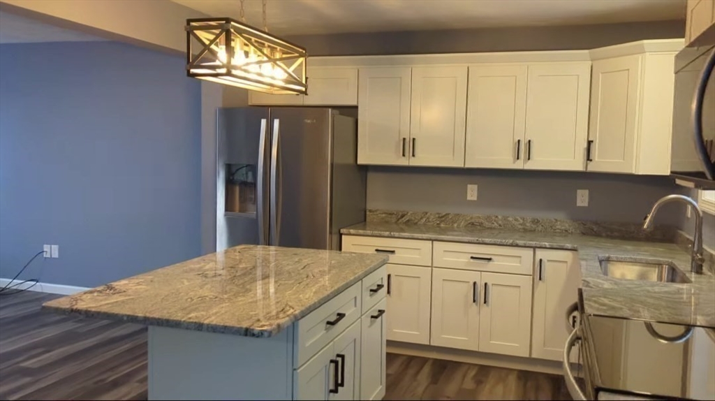514 Old County Road Holland, MA 01521 - Photo 7 of 40 a kitchen with cabinets appliances and a counter top space