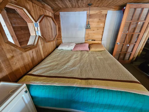 a bedroom with wooden floor and furniture