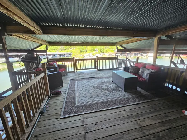 a view of a patio with table and chairs with wooden floor