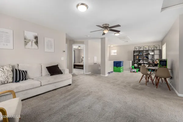 a living room with furniture and white walls