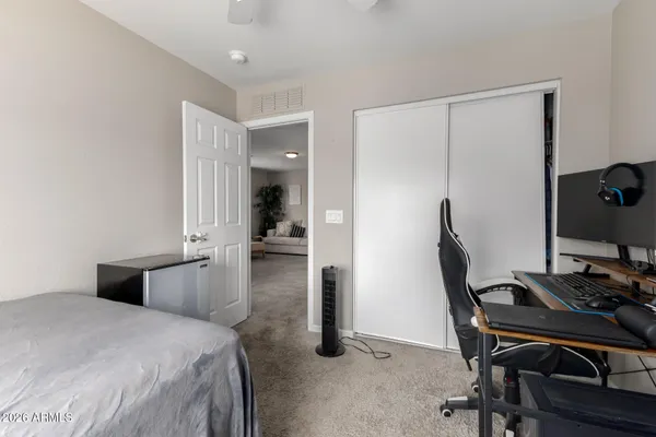a bedroom with a bed and a desk