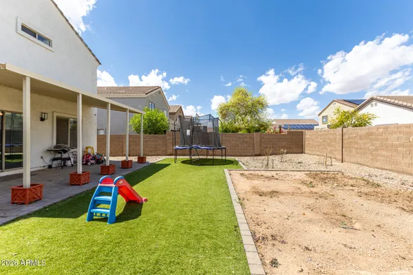 a view of a backyard with a table and chairs