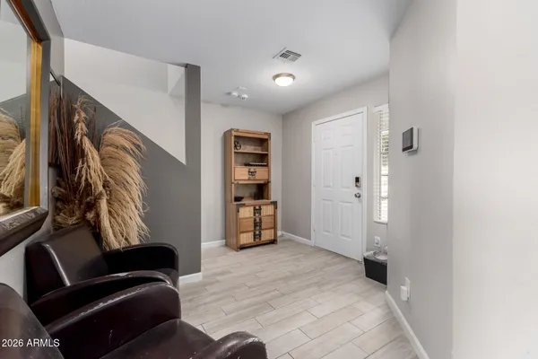 a view of a livingroom with furniture and a hallway