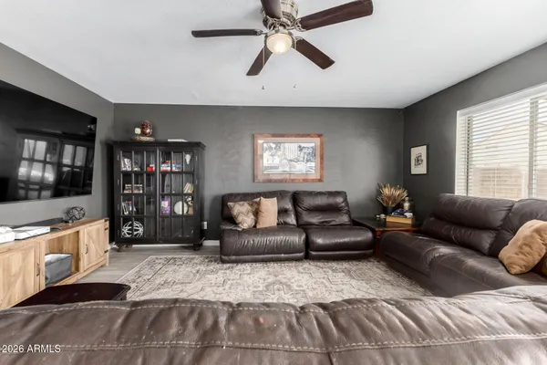 a living room with furniture and a hard wood floor