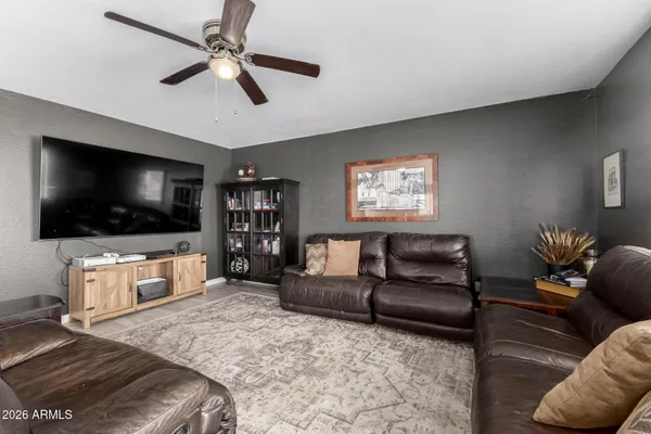 a living room with furniture and a flat screen tv