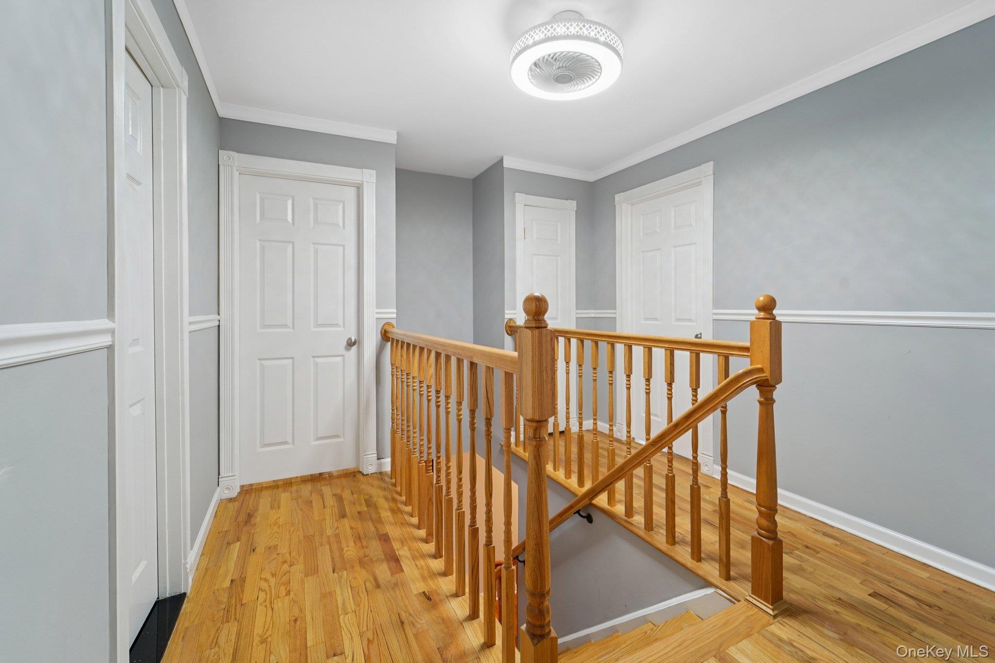 84 Townline Road Nanuet, NY 10954 - Photo 15 of 44 Hallway with an upstairs landing, light wood-style floors, and ornamental molding
