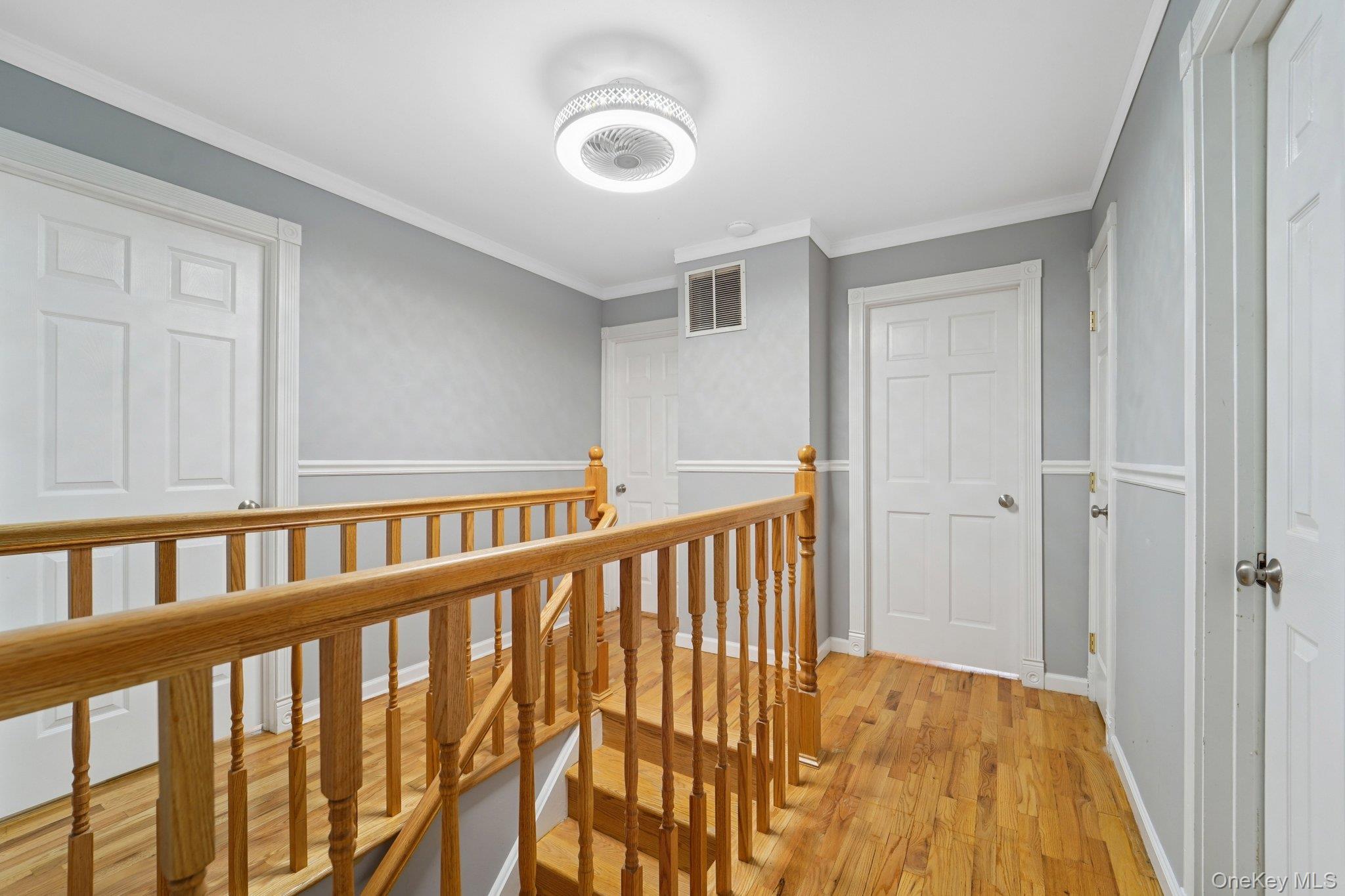 84 Townline Road Nanuet, NY 10954 - Photo 16 of 44 Hall with an upstairs landing, light wood-type flooring, and crown molding