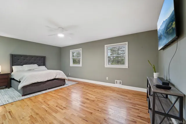a bedroom with a large bed and a window
