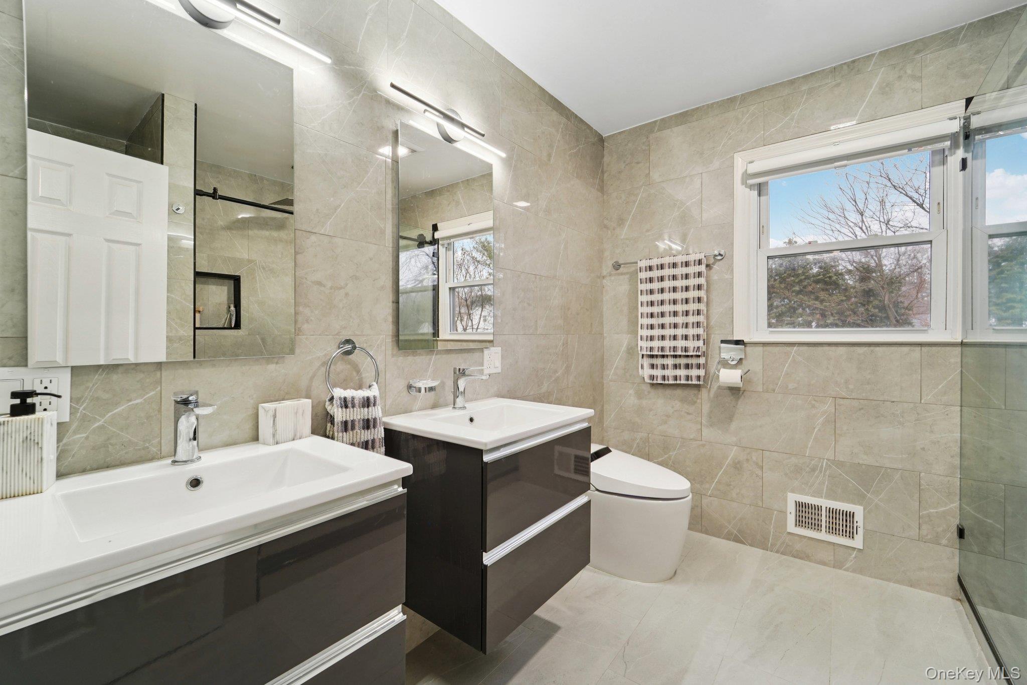 84 Townline Road Nanuet, NY 10954 - Photo 24 of 44 Full bathroom featuring tile walls, two vanities, and walk in shower