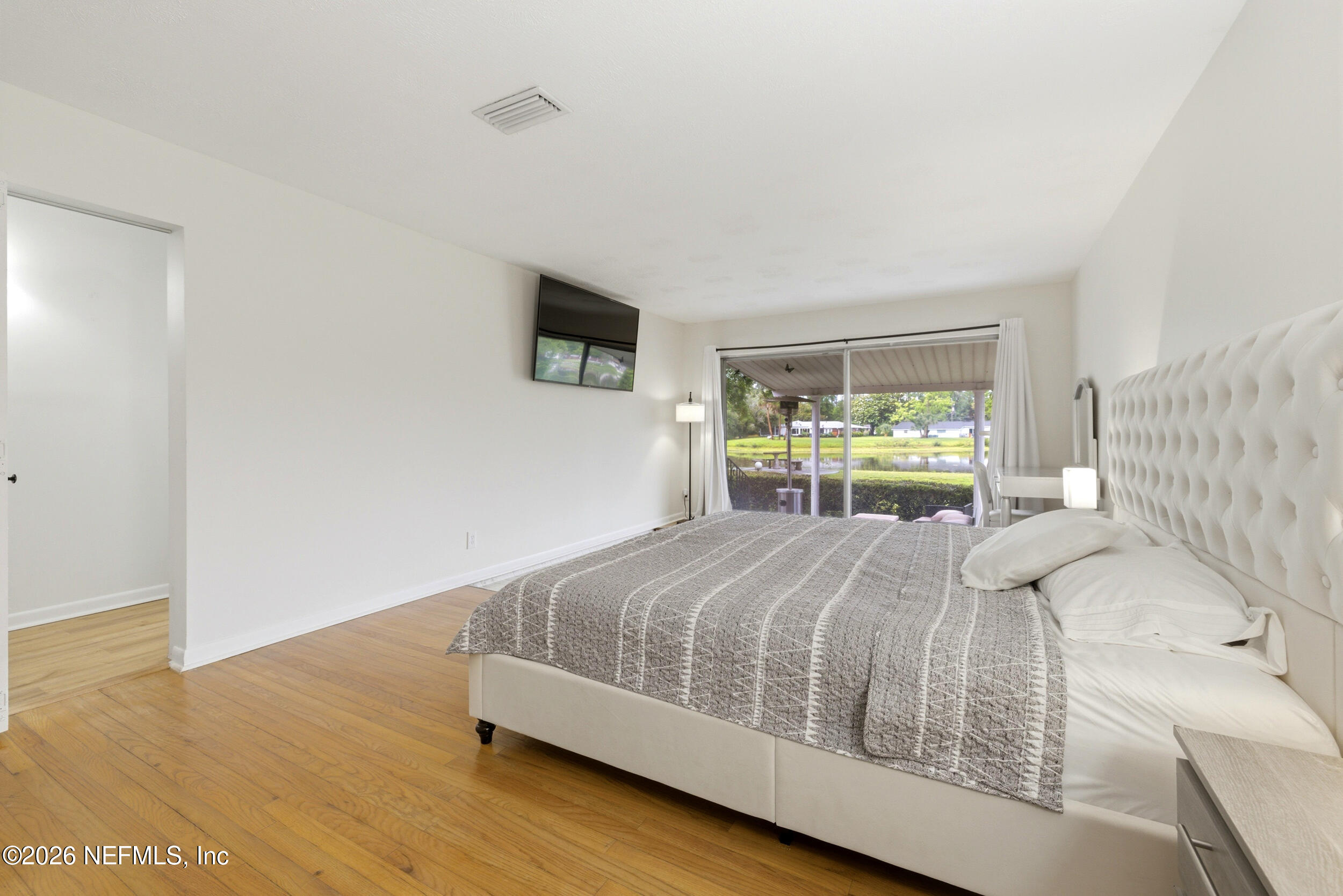 7484 Spinola Road Jacksonville, FL 32217 - Photo 28 of 63 a bedroom with a bed and a tv