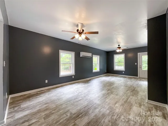 a view of a room with window and a ceiling fan