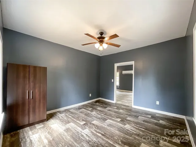 a view of a room with a ceiling fan