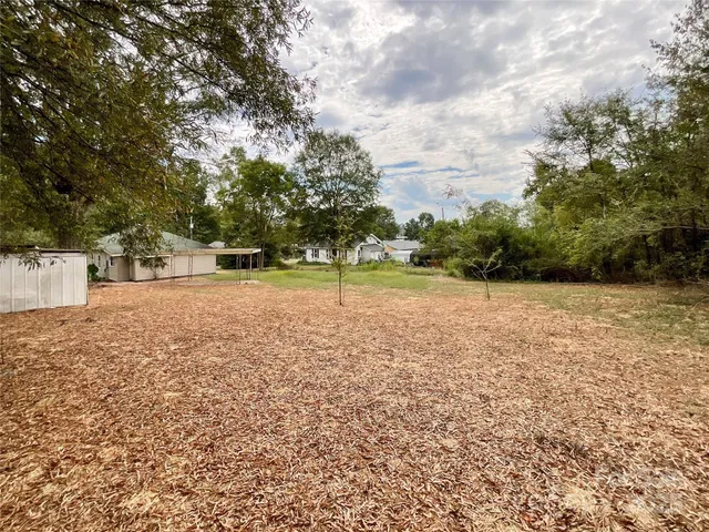a view of a field with trees in front of it