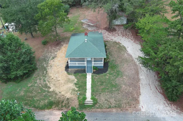 an aerial view of a house with a yard