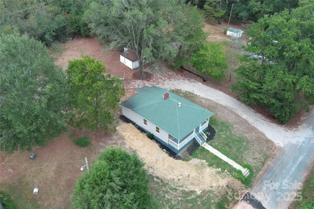 an aerial view of a house with a yard basket ball court and outdoor seating