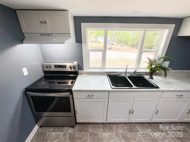 a view of a kitchen sink and a stove
