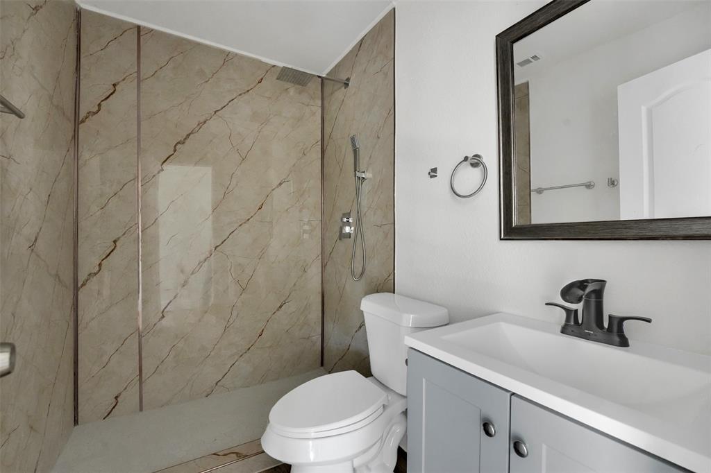 1507 East Lovers Lane Arlington, TX 76010 - Photo 13 of 18 a bathroom with a sink a toilet and shower