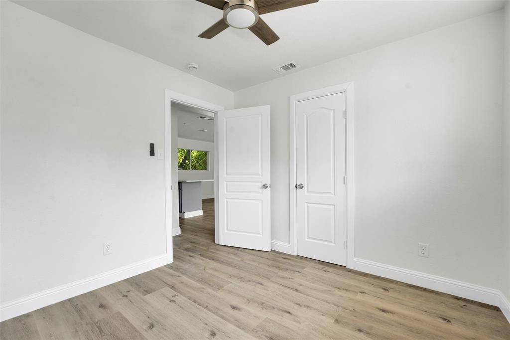 1507 East Lovers Lane Arlington, TX 76010 - Photo 14 of 18 a view of an empty room with window and wooden floor