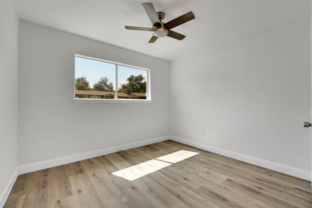 1507 East Lovers Lane Arlington, TX 76010 - Photo 15 of 18 an empty room with wooden floor and ceiling fan