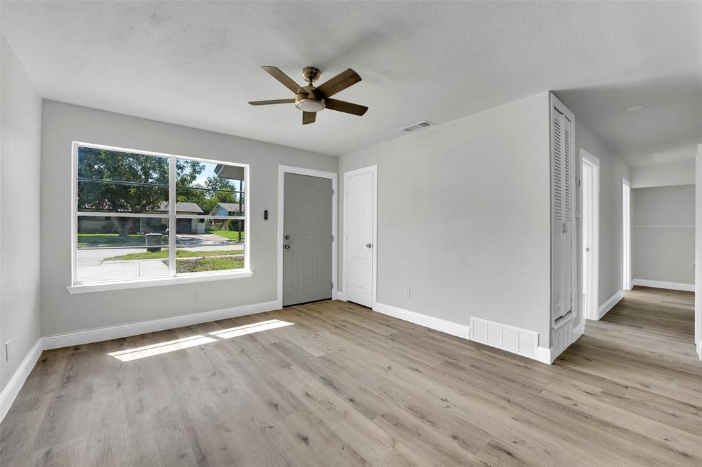 1507 East Lovers Lane Arlington, TX 76010 - Photo 3 of 18 a view of an empty room with wooden floor and a window